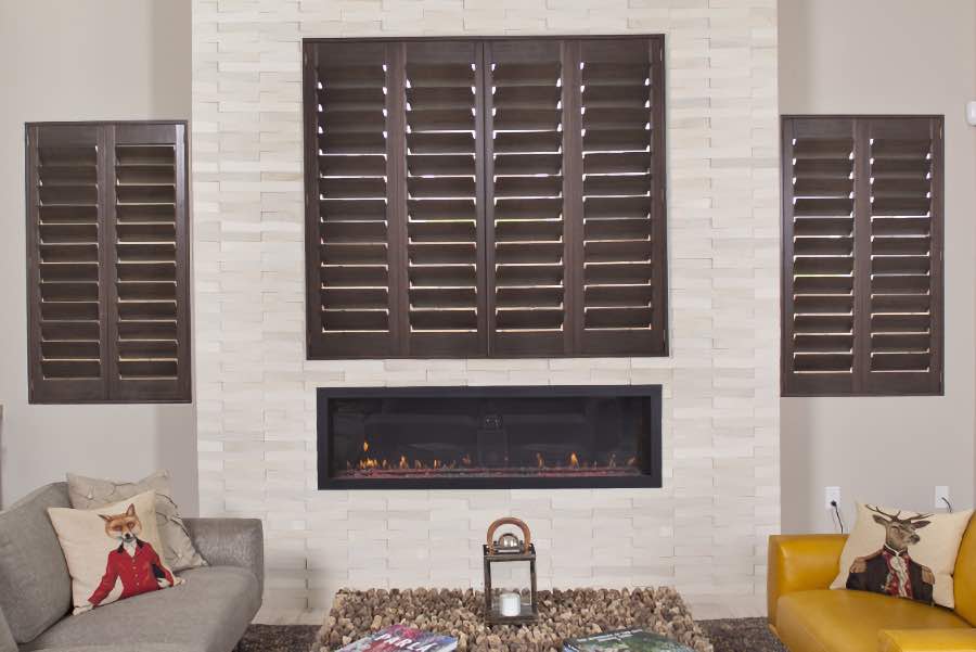 Brown wood shutters in an off-white living room